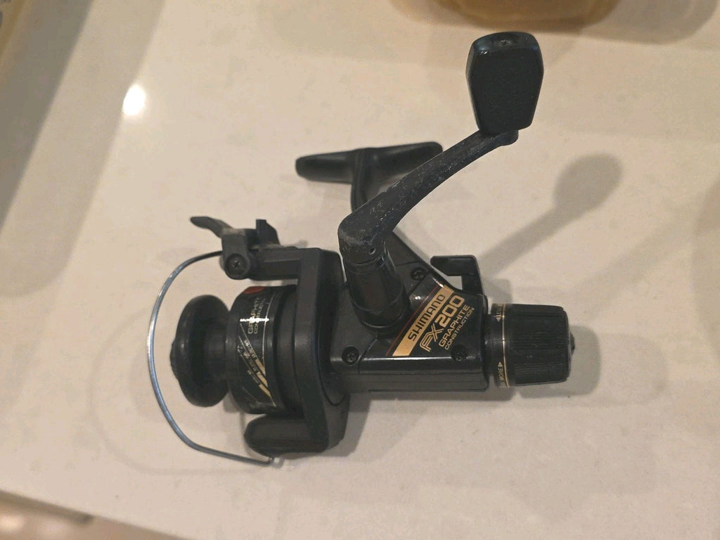 Fishing SHIMANO FX200 Graphite Spinning Reel with Rear Drag & Quickfire II ￼ Nic
