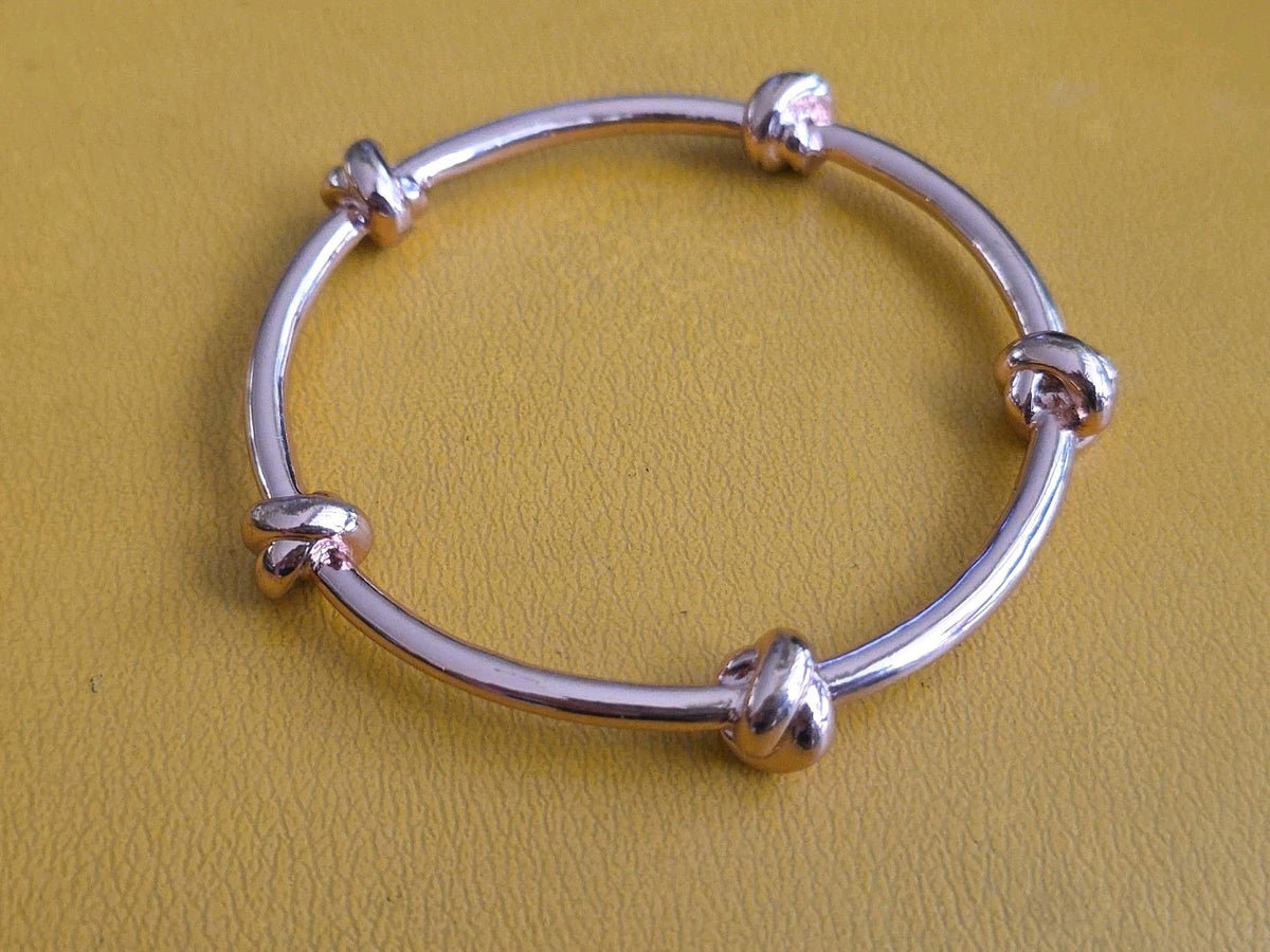 CC SKYE Love Me Knot Gold Tone Bangle Bracelet